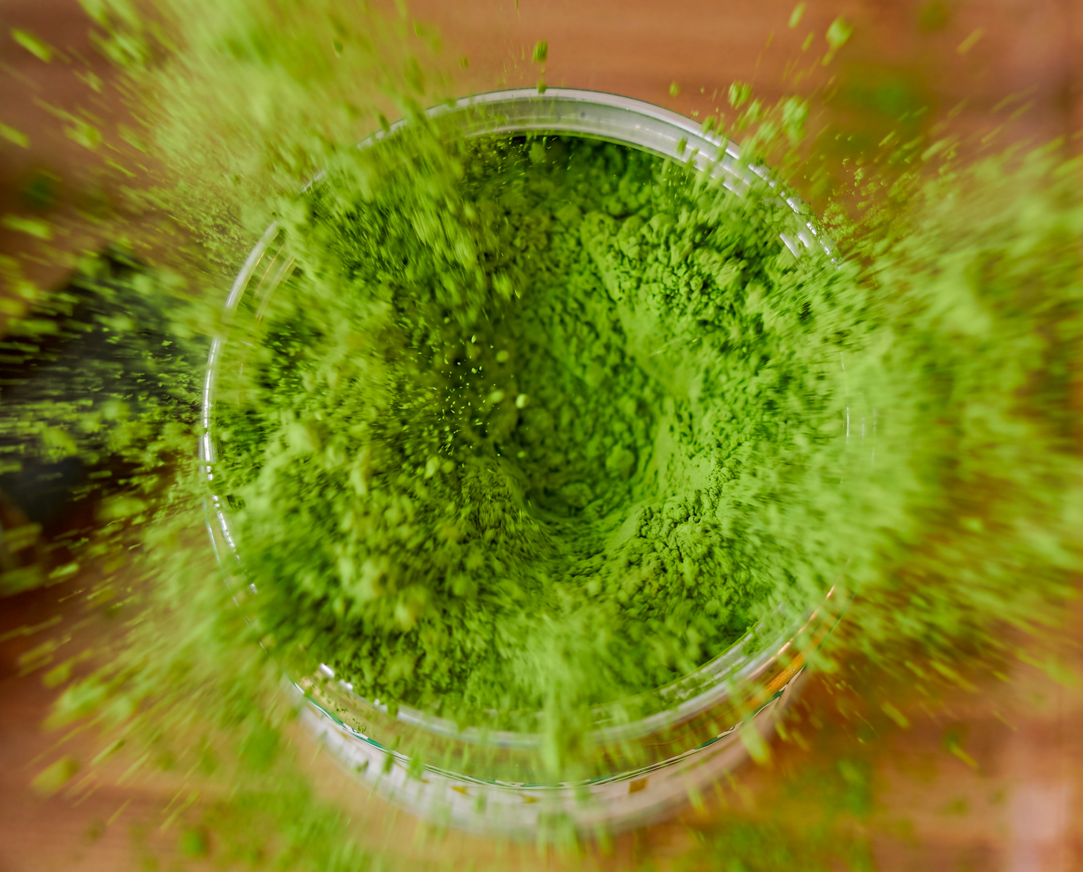 KYO-T Organic Matcha packaging with matcha powder exploding around the tin